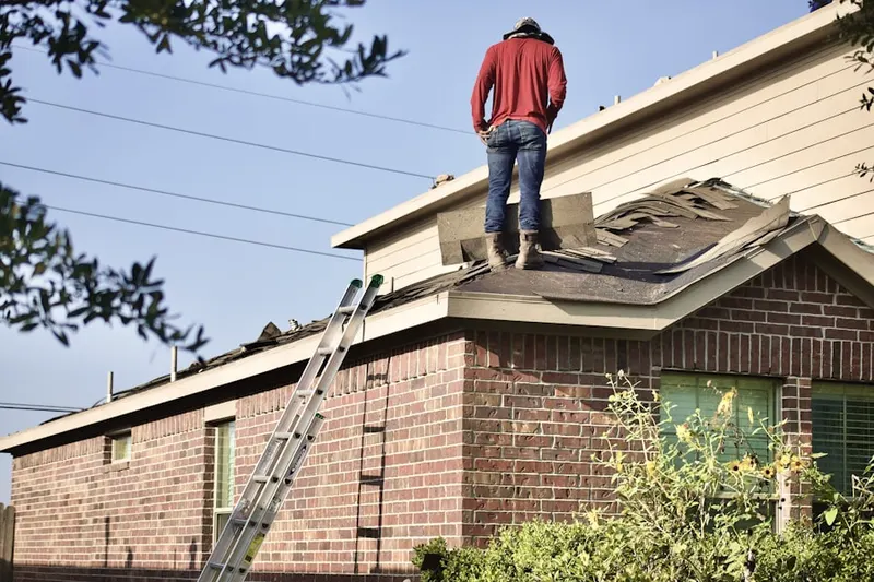 Professional roofer working on a residential roof in Ledgewood